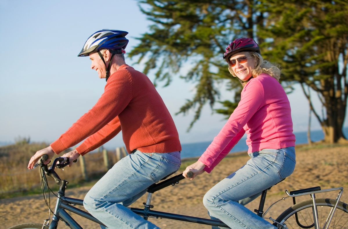 older man and woman on tandem bike