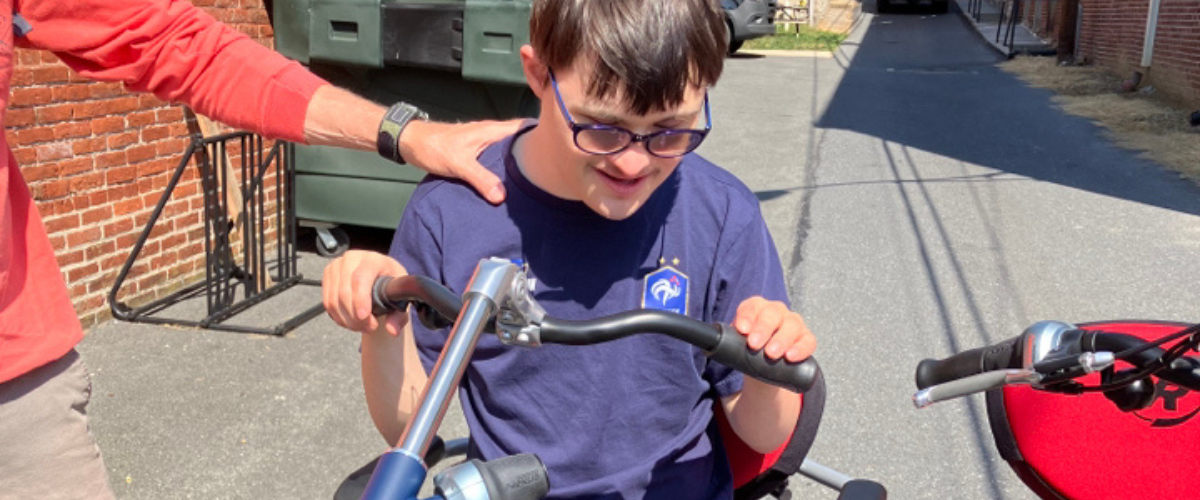 young man with down syndrome on adaptable bike