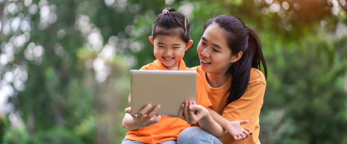 child with mom using an ipad