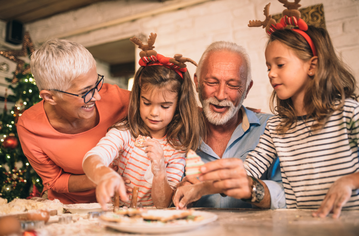 2 girls with grandparents making Christmas cookies