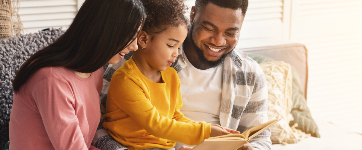 mom and dad reading with young girl