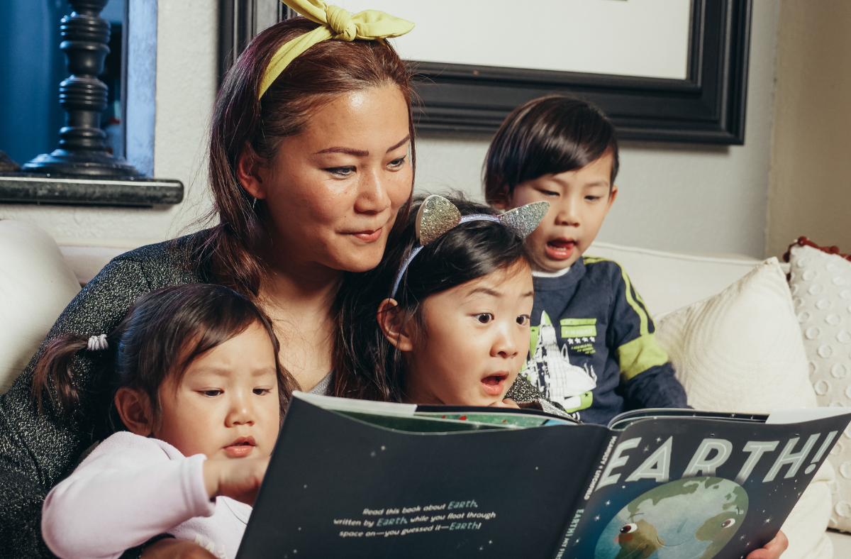 mom reading with 3 kids