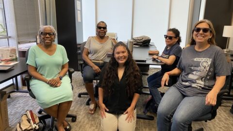 Smiling group of 5 women, 3 of them wearing meta glasses