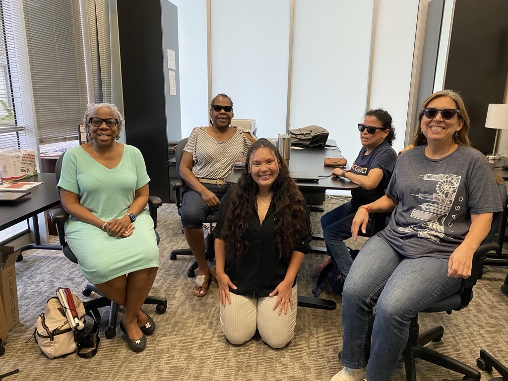 Smiling group of 5 women, 3 of them wearing meta glasses