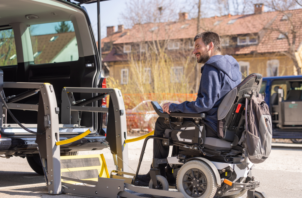 man in wheelchair entering a vehicle wheelchair lift