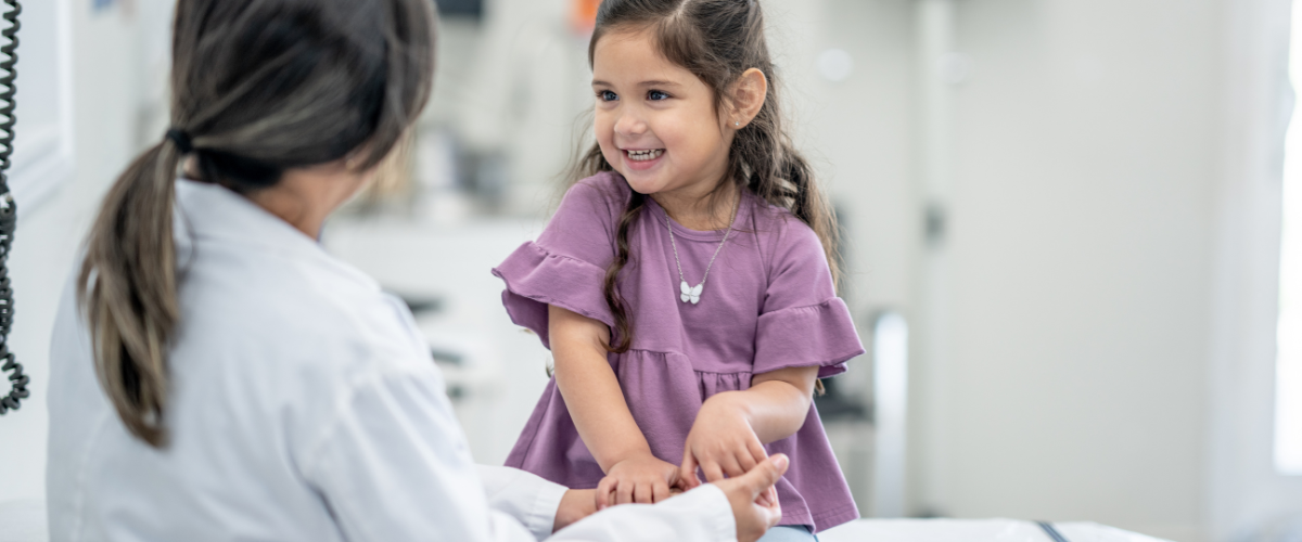 girl sitting with health provider in office