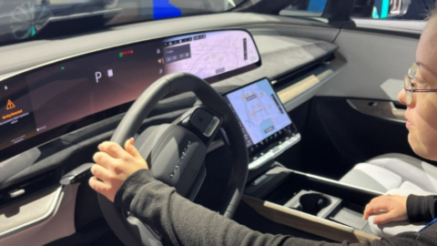 young woman sitting in car at tech conference